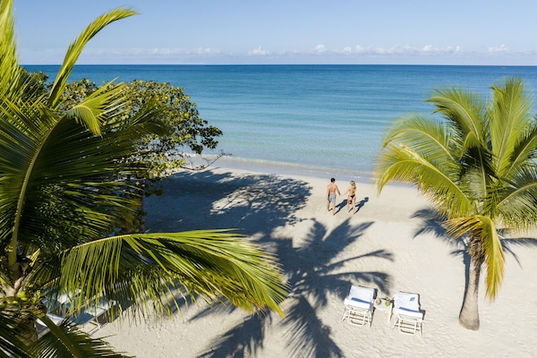 On the beach, white sand, sun loungers, beach towels