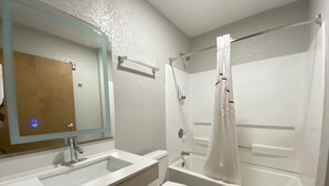 A bathroom with a sink, toilet, and bathtub. - Red Roof Inn Winston-Salem (Winston-Salem)