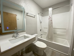 A bathroom with a sink, toilet, and bathtub. - Red Roof Inn Winston-Salem (Winston-Salem)