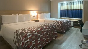 A hotel room with two beds, a desk, and a window with curtains. - Red Roof Inn Winston-Salem (Winston-Salem)