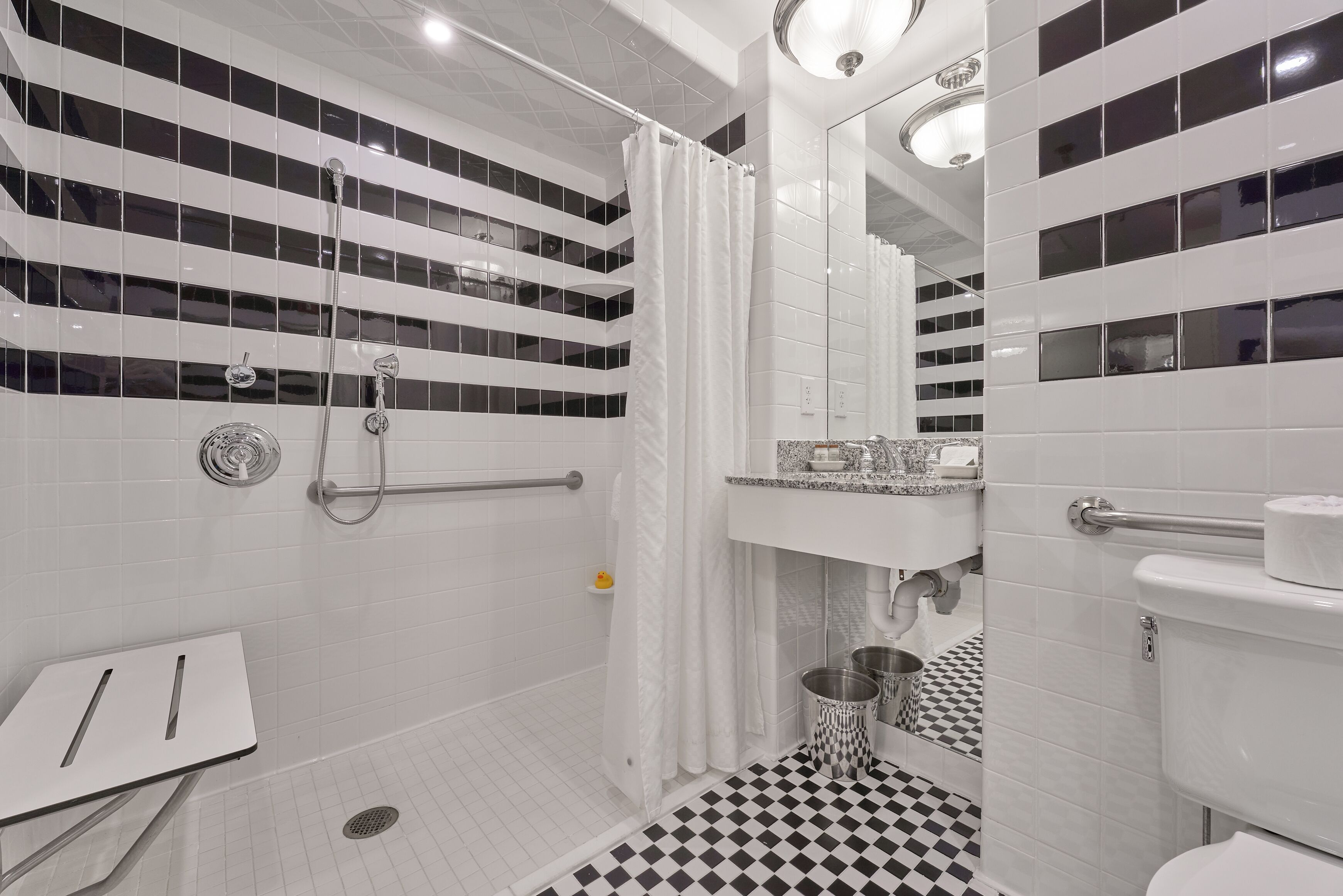 A modern bathroom with a shower, toilet, and sink.