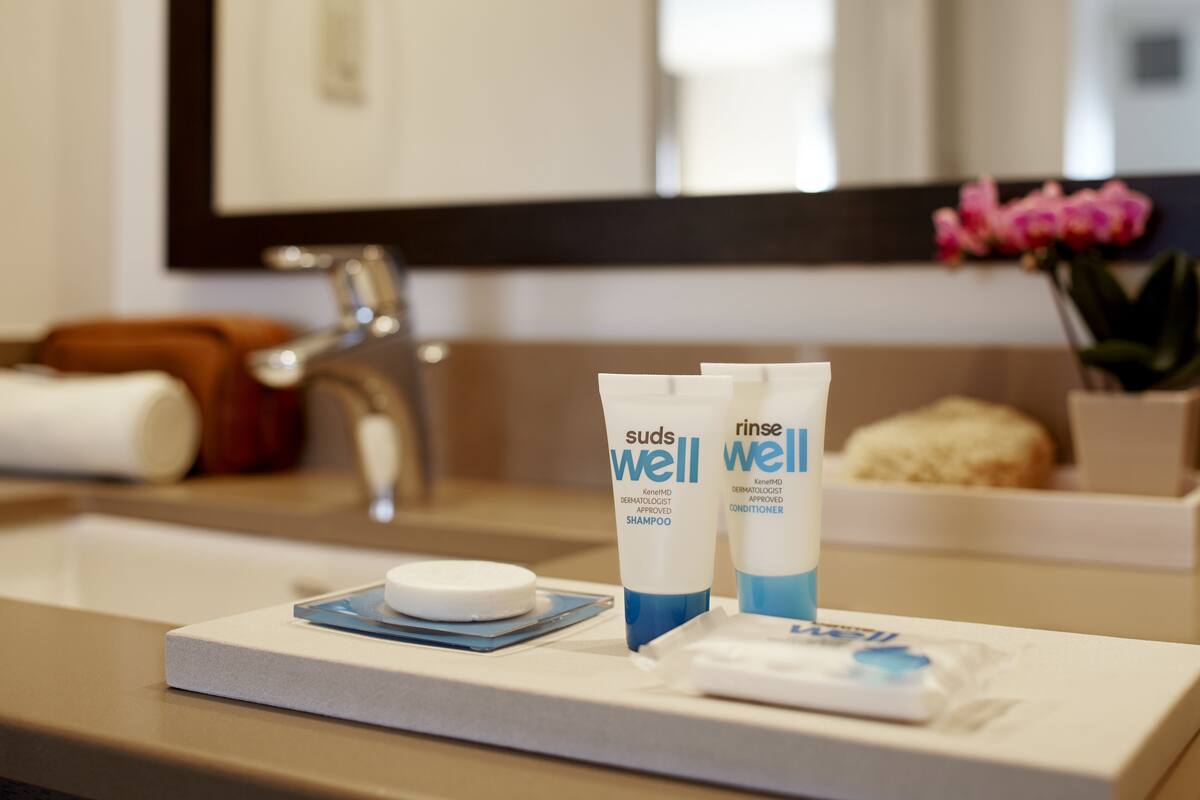 designer toiletries, hair dryer, towels