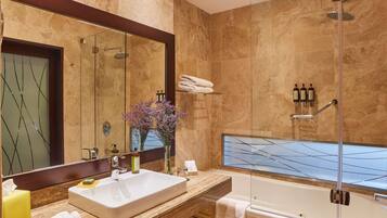 A modern bathroom with a large mirror, a sink, a shower, and a bathtub.
