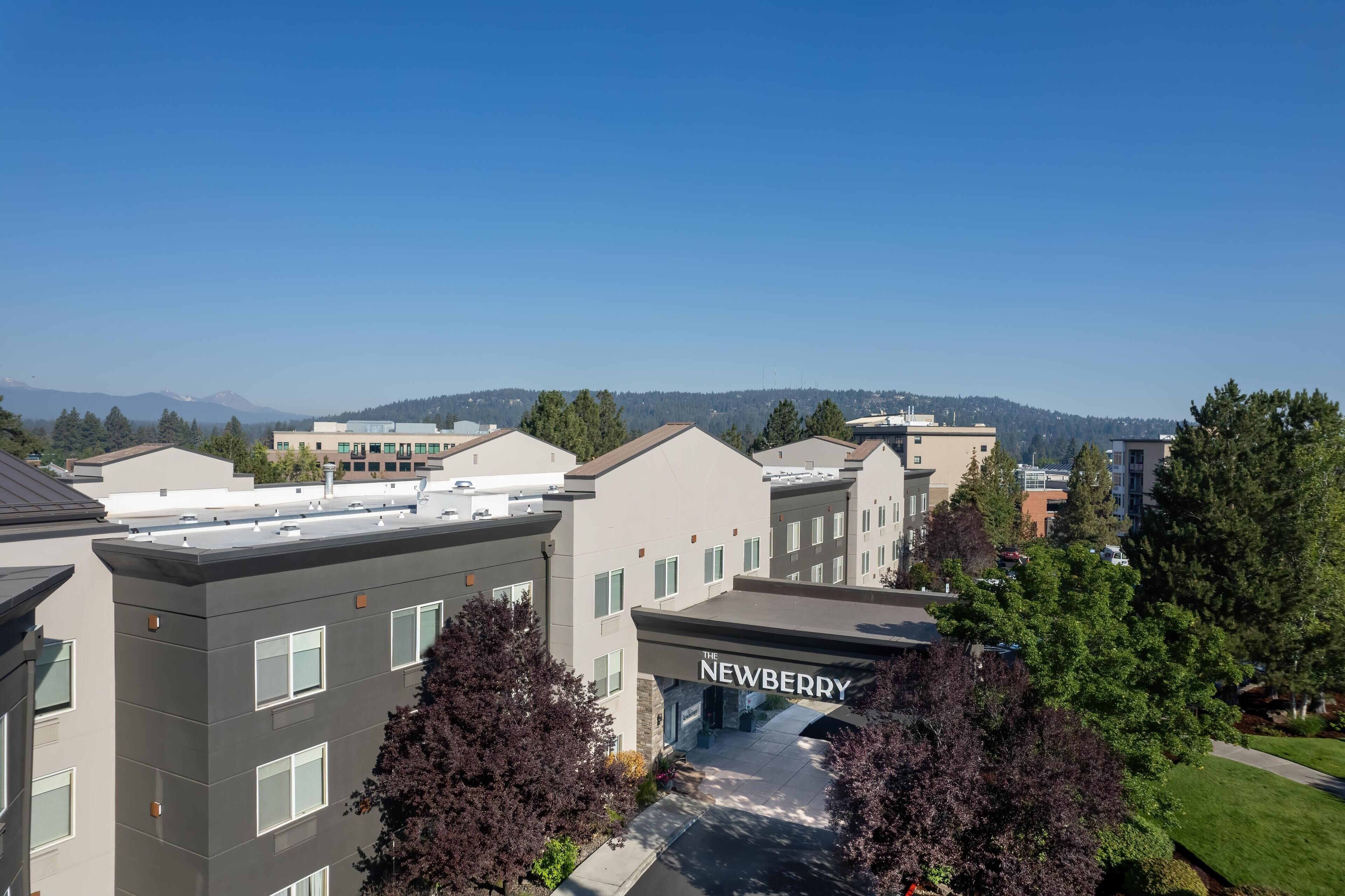 A multi-story building with a sign reading 'The Newberry.'