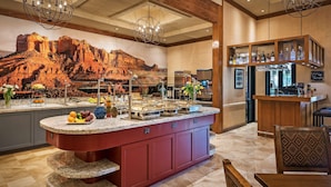 A kitchen with a large island, granite countertops, and a mural of a desert landscape. - Sonesta Suites Scottsdale Gainey Ranch (Scottsdale)