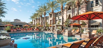 Outdoor pool, open 6 AM to 10:00 PM, pool umbrellas, sun loungers at Sonesta Suites Scottsdale Gainey Ranch
