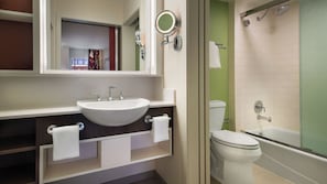 A bathroom with a white sink, a toilet, and a shower. - Disney's All-Star Movies Resort (Lake Buena Vista)