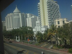 A cityscape with high-rise buildings, palm trees, and a clear sky. - Geneva Hotel (Miami Beach)