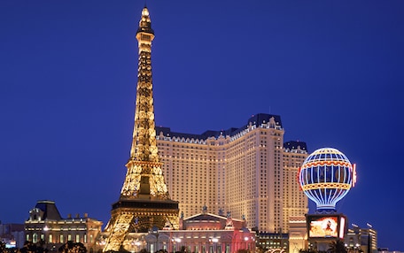 The Eiffel Tower and a large hotel with a dome-shaped structure in the foreground.
