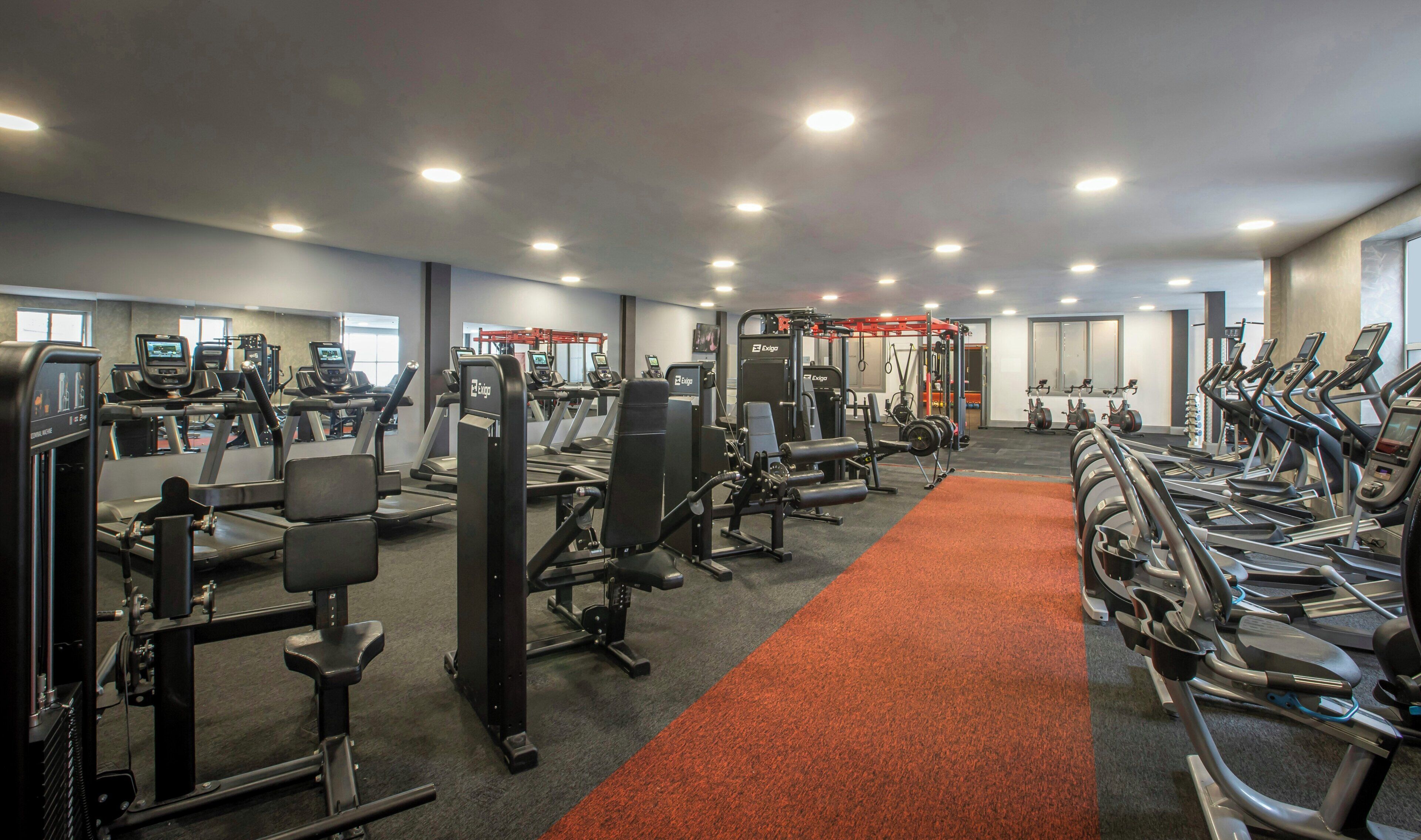 A gym with treadmills, weight machines, and cardio equipment.