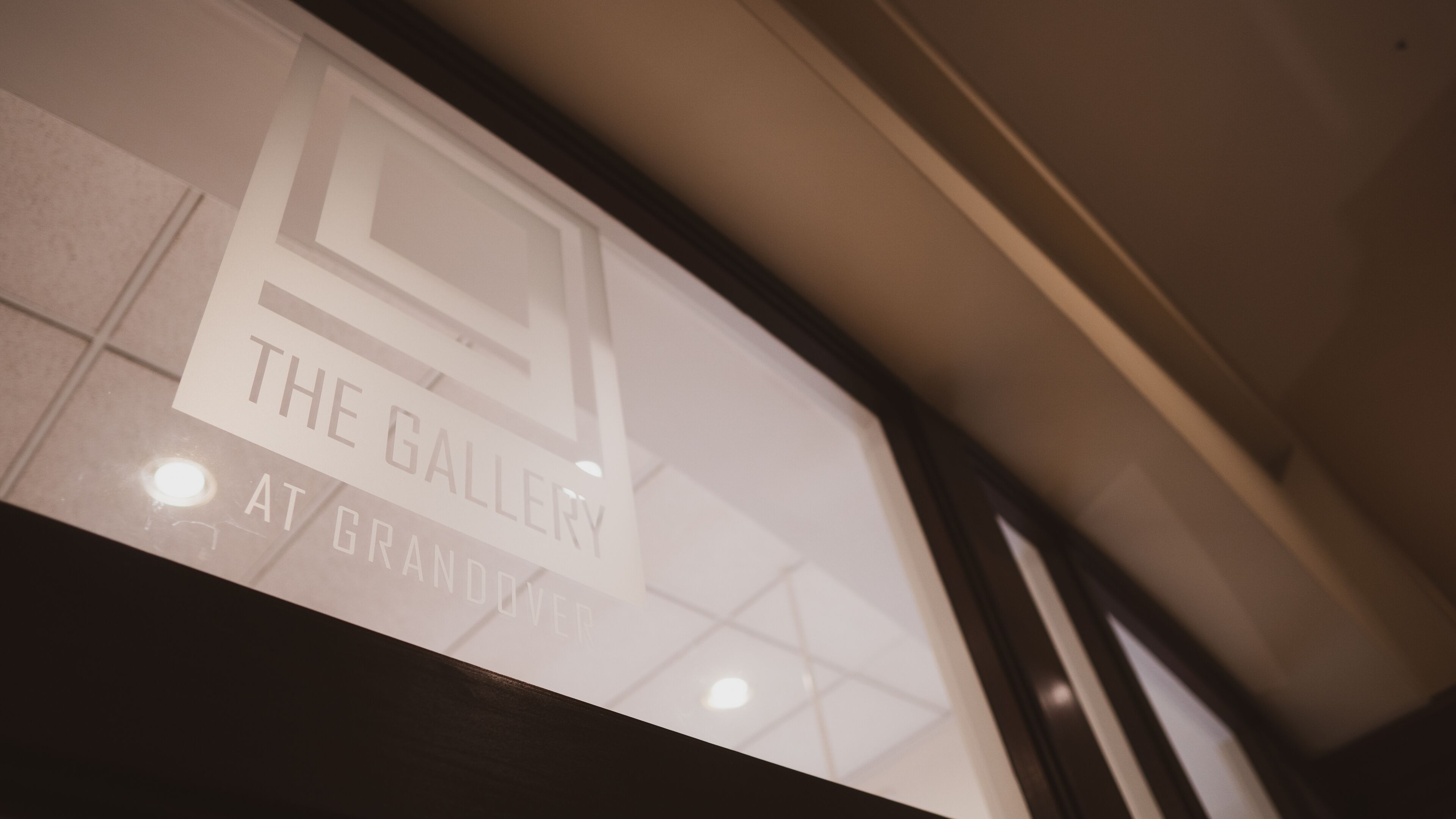 A sign for 'The Gallery at Grandview' with a geometric design.