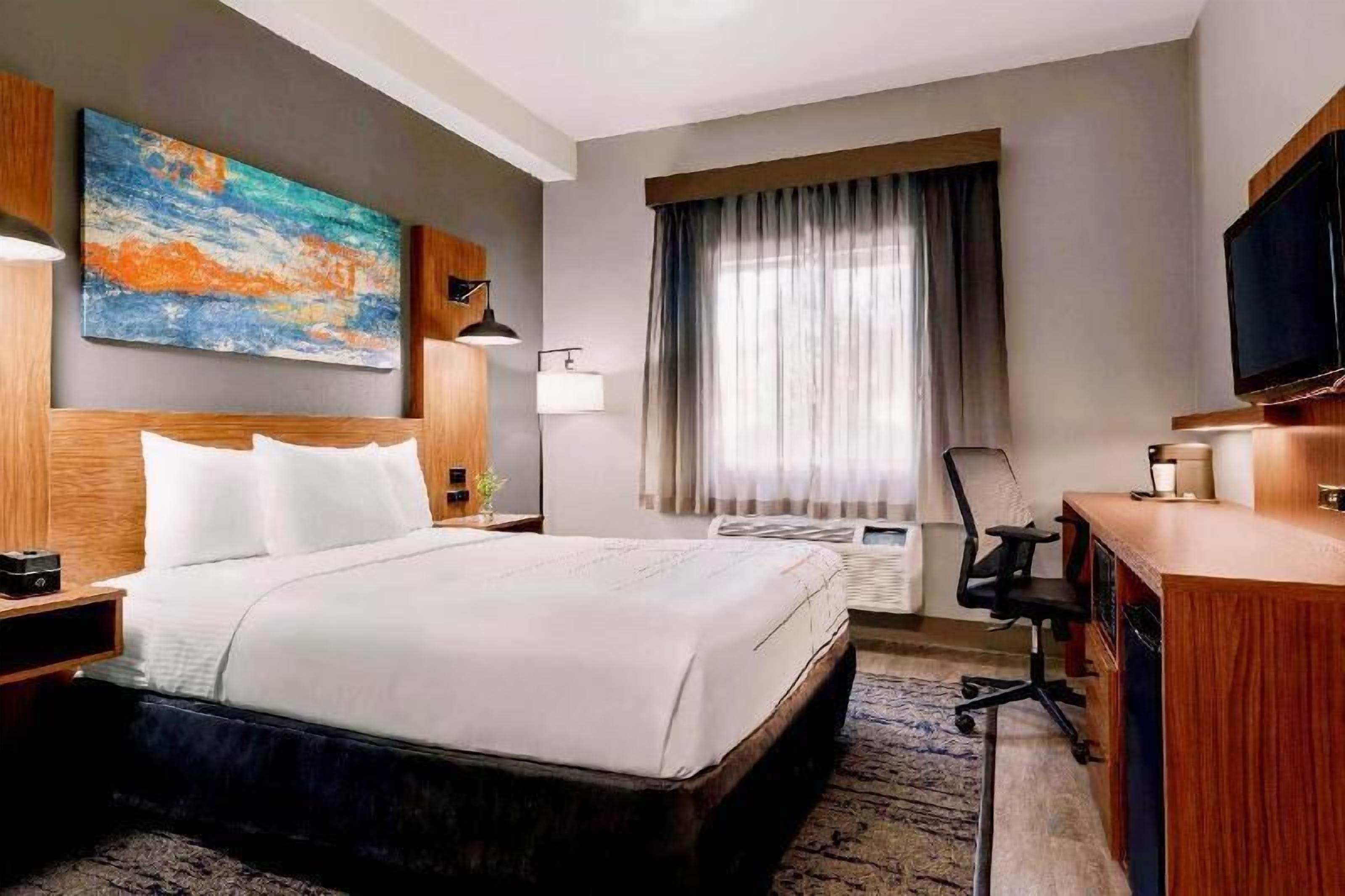 Premium bedding, desk, laptop workspace, blackout drapes