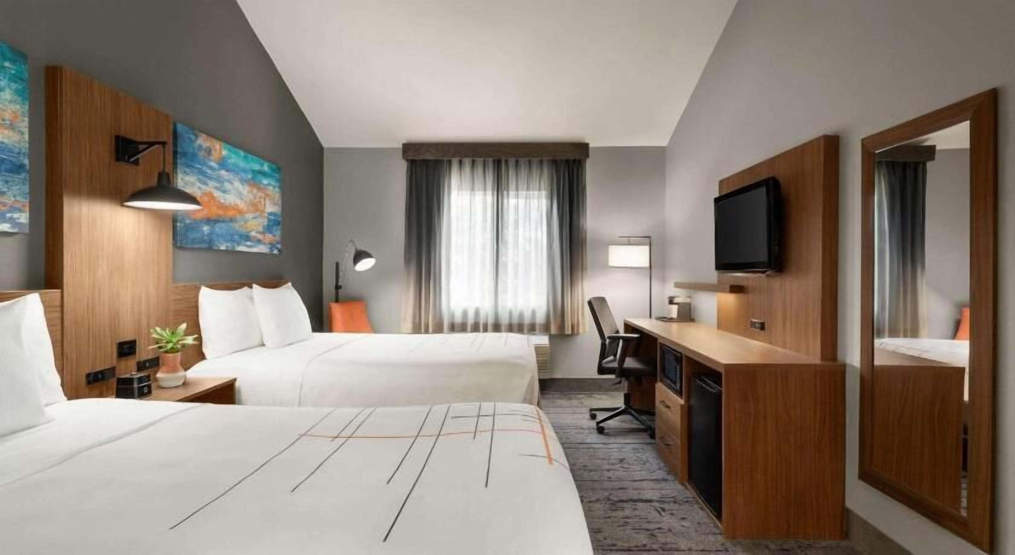 Premium bedding, desk, laptop workspace, blackout drapes