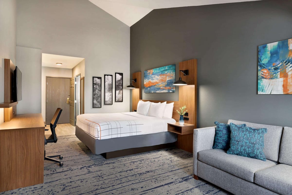 Premium bedding, desk, laptop workspace, blackout drapes