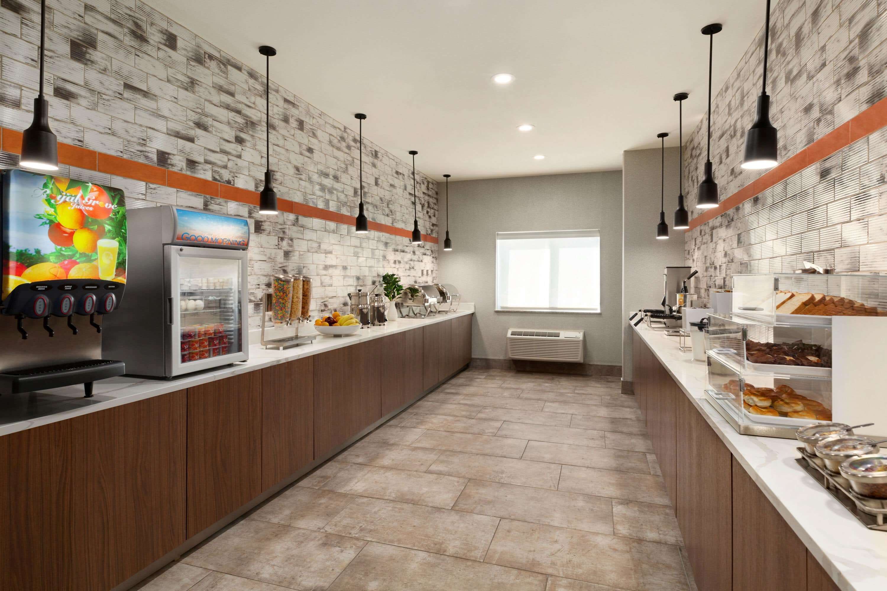 A modern kitchen with a coffee machine, refrigerator, and various food items on the counter.