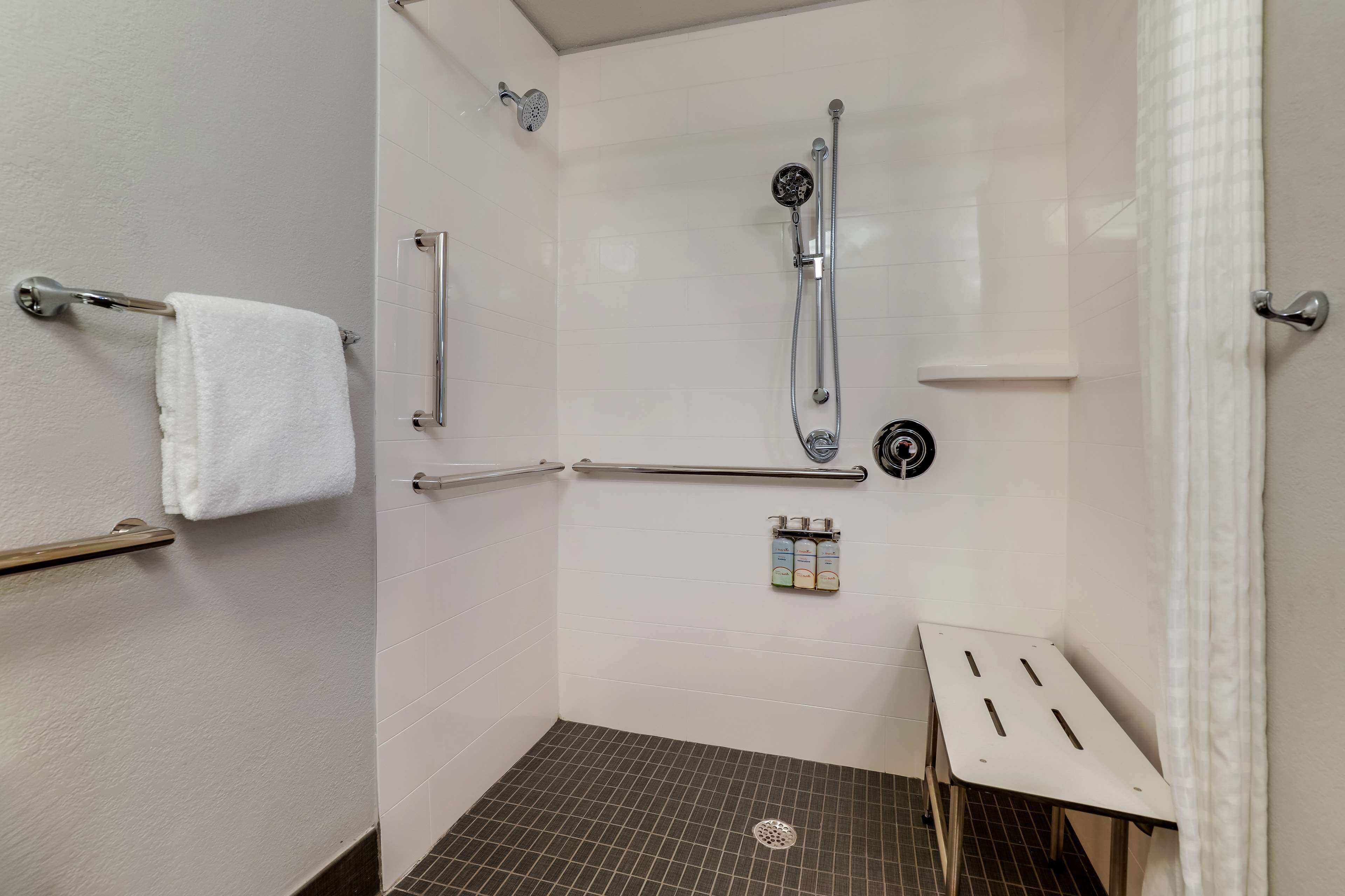 separate bathtub and shower, hair dryer, towels