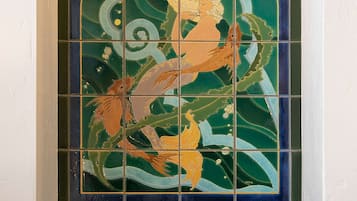 A stained glass window with a mermaid and fish design.