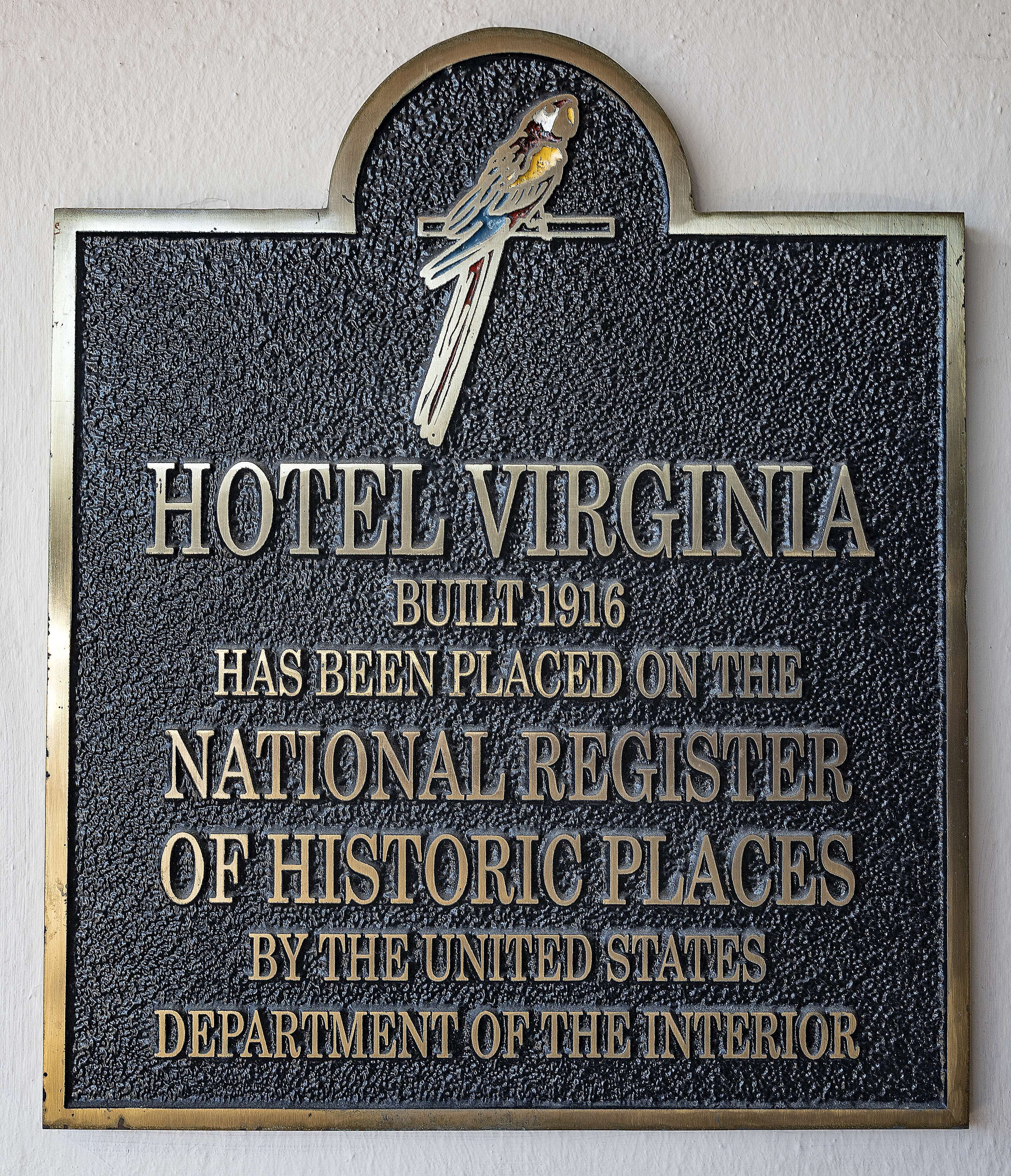 A plaque with the text "HOTEL VIRGINIA BUILT 1916 HAS BEEN PLACED ON THE NATIONAL REGISTER OF HISTORIC PLACES BY THE UNITED STATES DEPARTMENT OF THE INTERIOR."