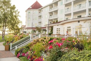 A multi-story hotel with a central courtyard, a red-roofed tower, and a white exterior.