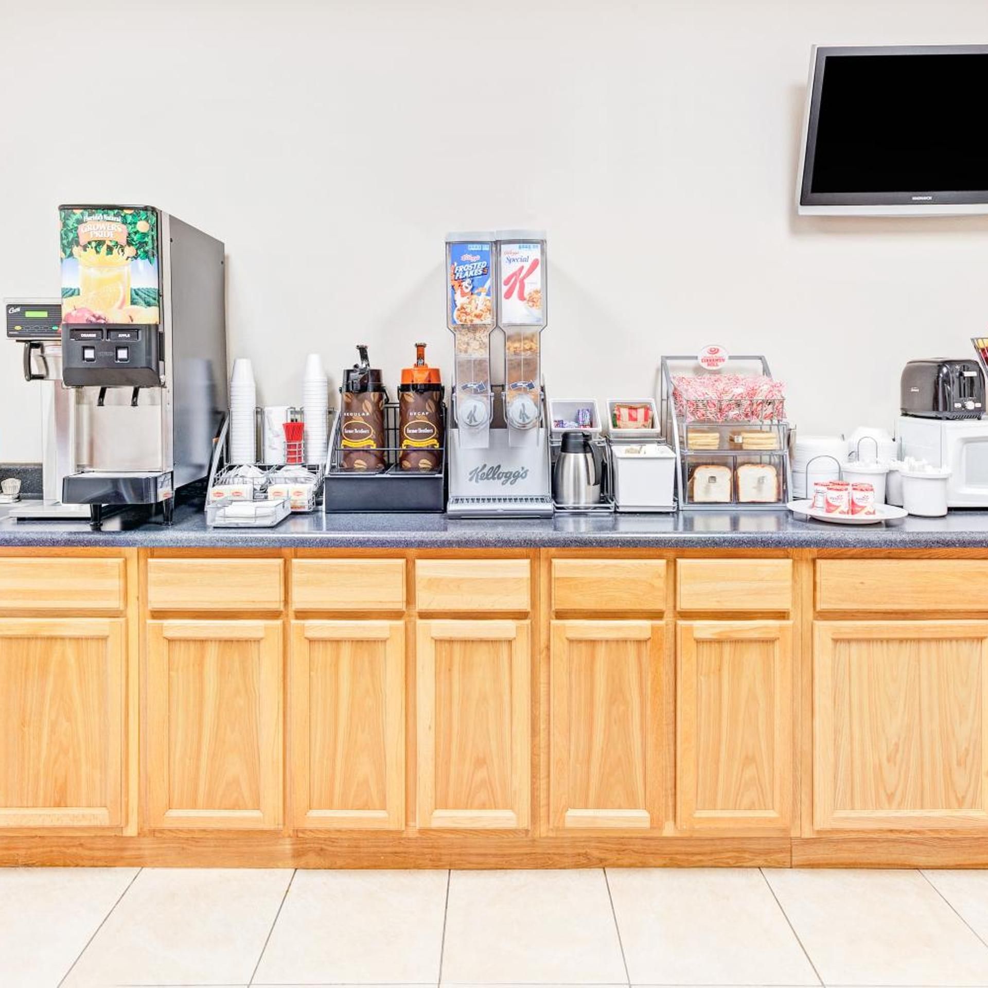 A breakfast bar with a coffee machine, a cereal dispenser, and a toaster.