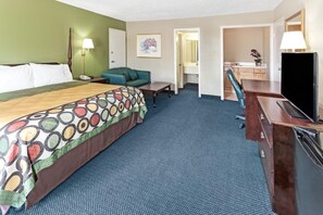 A hotel room with a large bed, a desk, a chair, a television, and a bathroom visible through an open door. - Super Inn & Suites Carrollton,West Georgia (Carrollton)