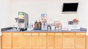 A kitchen with a coffee machine, a microwave, a toaster, and a kettle. - Super Inn & Suites Carrollton,West Georgia (Carrollton)