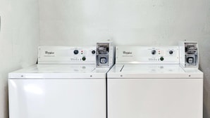 Two Whirlpool washing machines side by side in a laundry room. - Super Inn & Suites Carrollton,West Georgia (Carrollton)