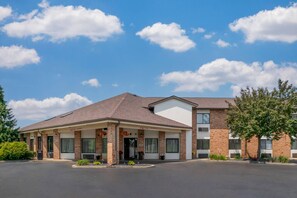 A two-story hotel with a covered front porch and a 'NO TRUCKS' sign.