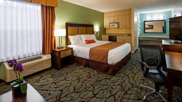 Relax in this cozy space with a comfortable bed, desk, and kitchenette.