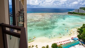 A beachfront hotel with a view of the ocean, a sandy beach, and a clear sky. - Dusit Beach Resort Guam (Tamuning)