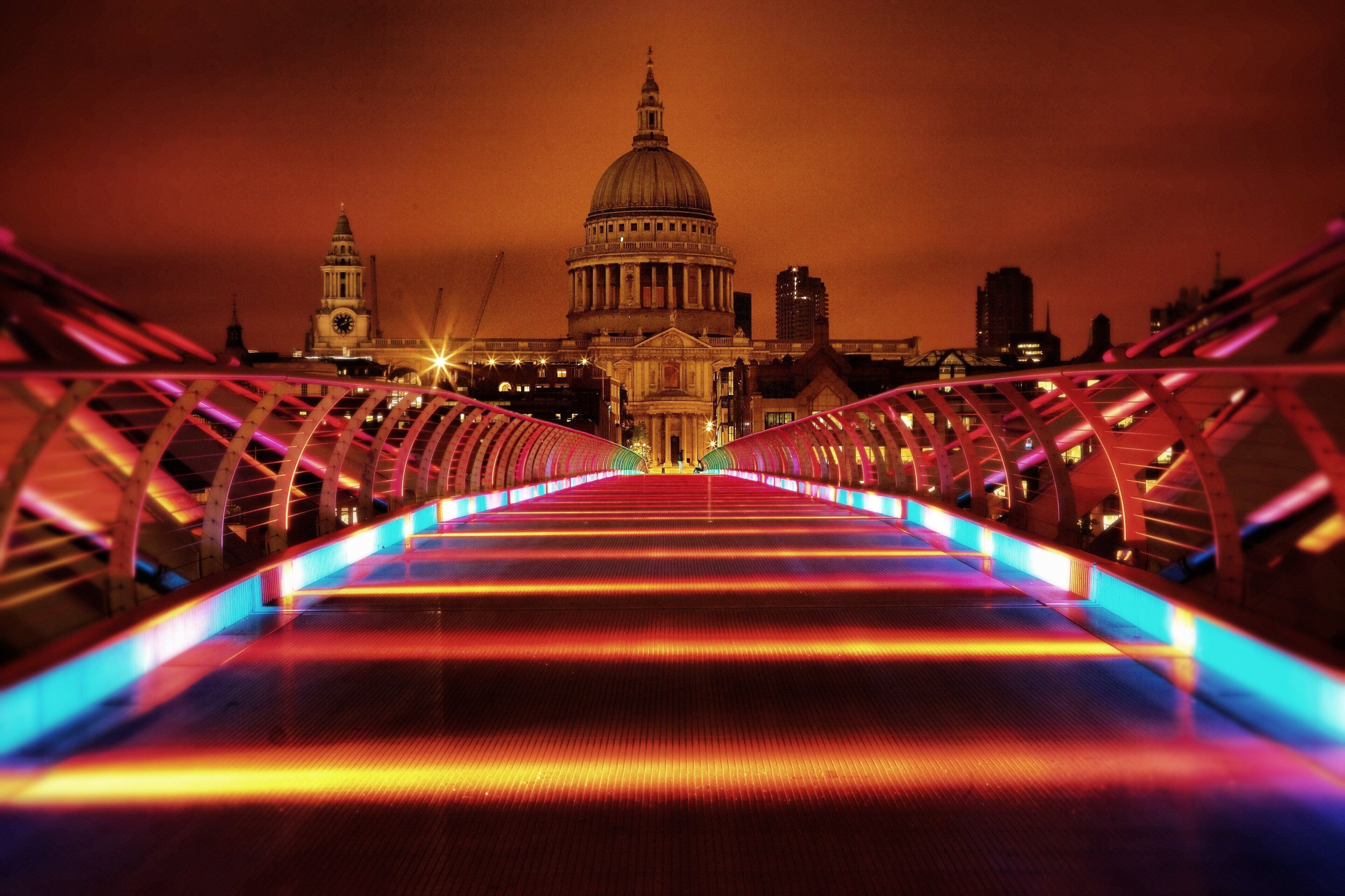 A bridge with a view of a large domed building in the background.