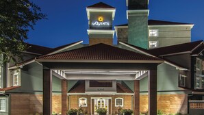 A hotel entrance with a prominent sign reading "LA QUINTA" and the number "6260" above the door. - La Quinta Inn & Suites by Wyndham Atlanta Perimeter Medical (Atlanta)
