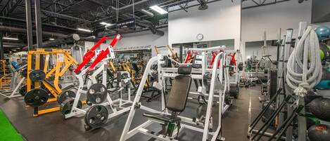 A gym with various exercise equipment, including weight machines and free weights.