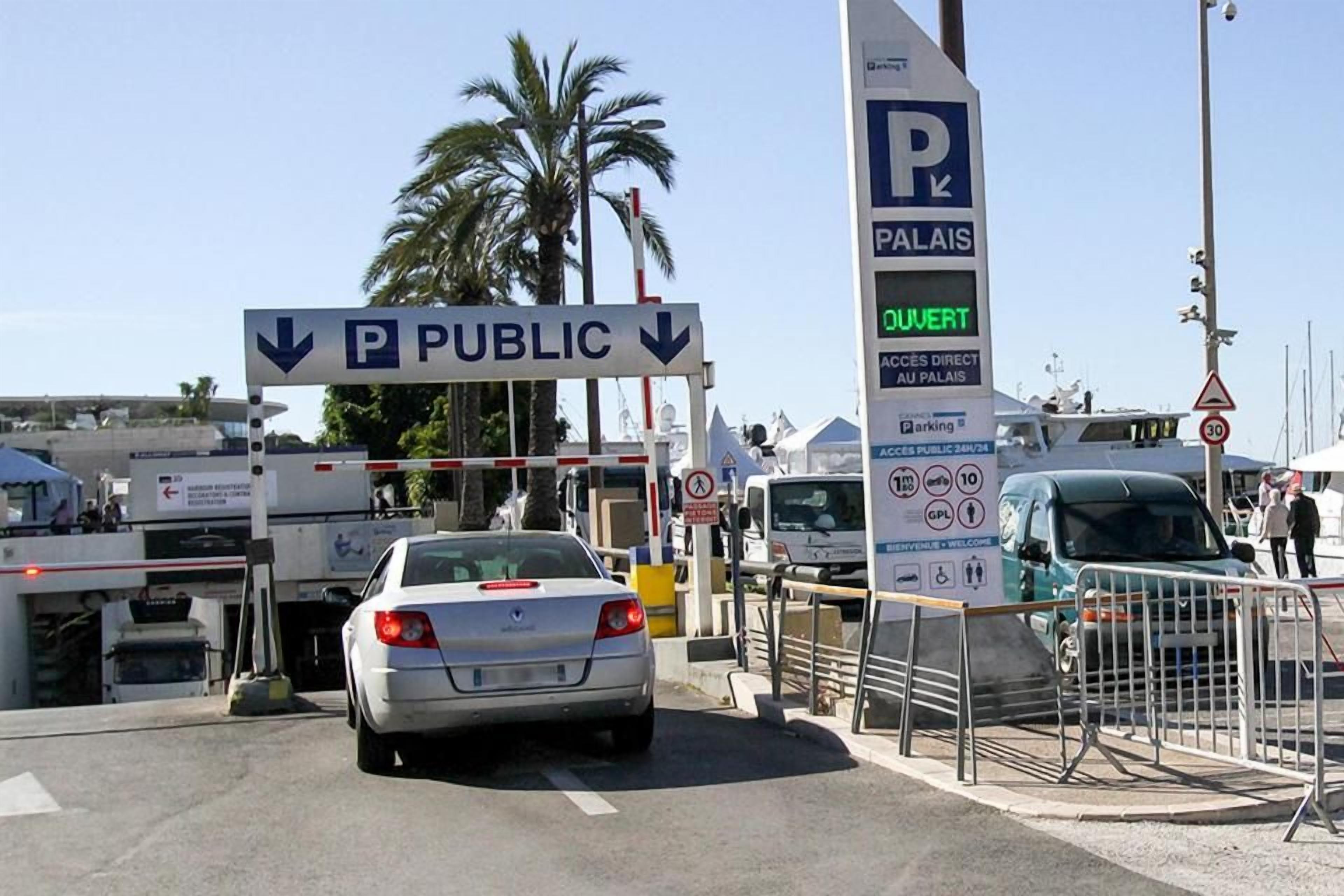 A public parking area with a sign indicating access to a specific location.