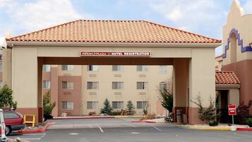 A hotel registration area with a tiled roof and a sign above the entrance.