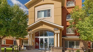 A hotel entrance with a number sign, a glass door, and a small balcony. - Extended Stay America Suites Denver Aurora North (Aurora)