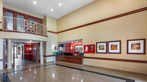 A spacious lobby with a reception desk, framed pictures on the wall, and a second-floor balcony. - Extended Stay America Suites Denver Aurora North (Aurora)