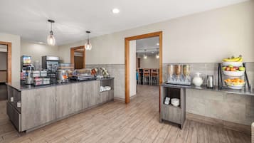 A modern kitchen with a central island, built-in appliances, and a breakfast bar.