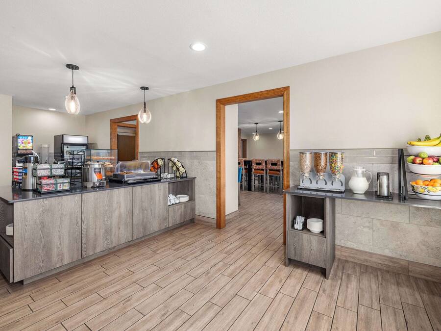 A modern kitchen with a central island, built-in appliances, and a breakfast bar.
