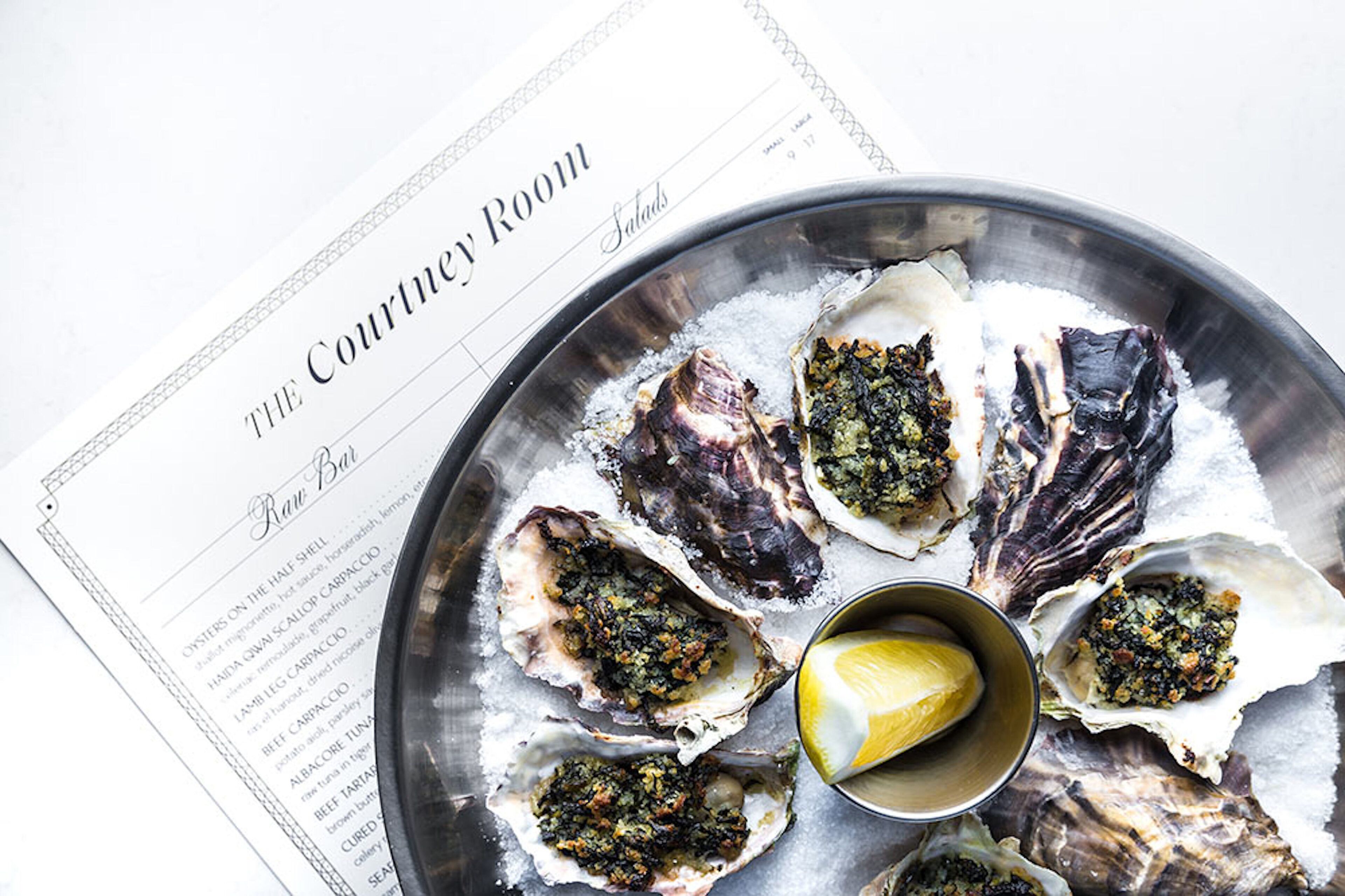 A menu titled "THE Courtery Room" with a list of dishes including oysters on the half shell and salads.