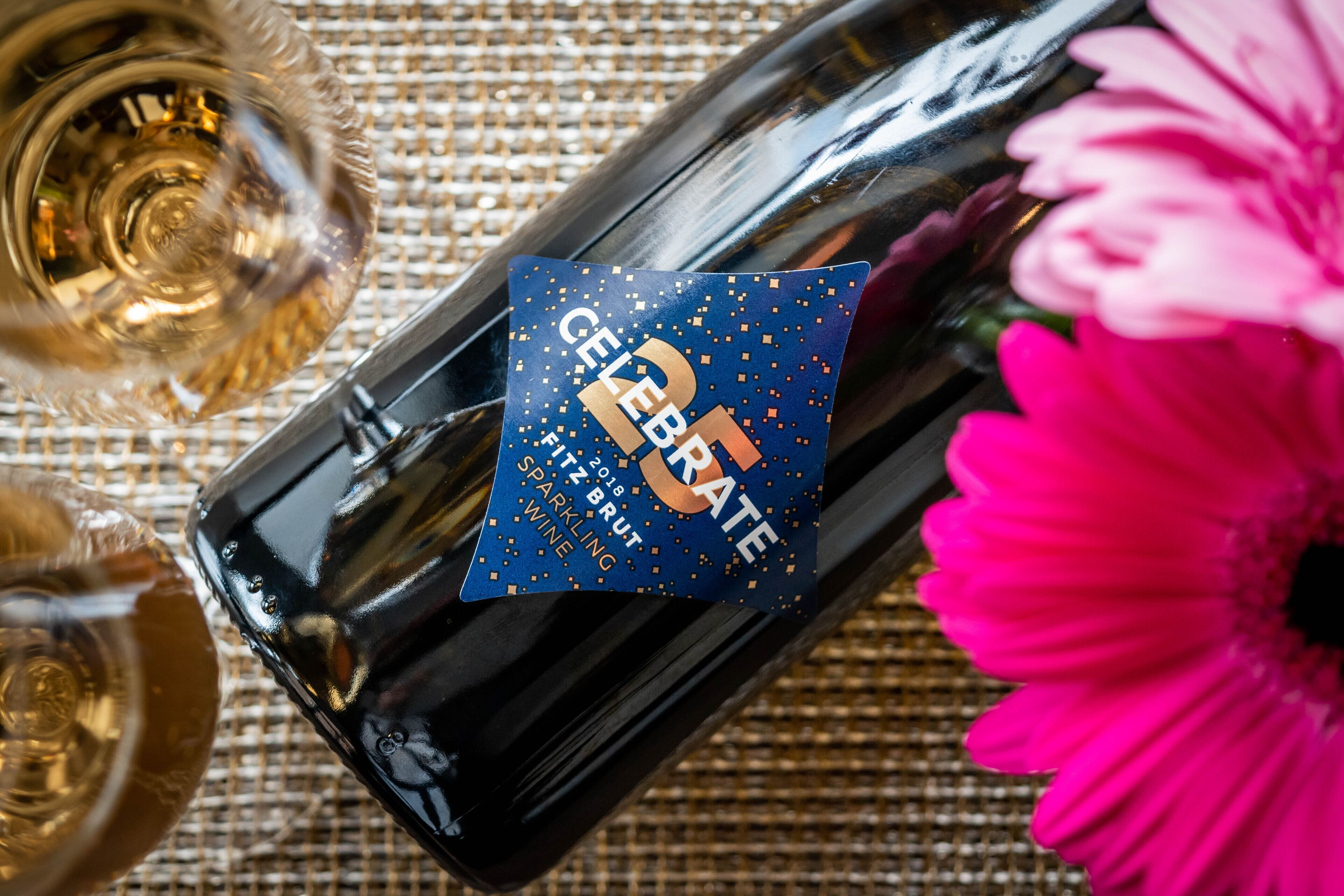 A bottle of sparkling wine with a label that reads "CELEBRATE 2018 BRUT SPARKLING WINE."