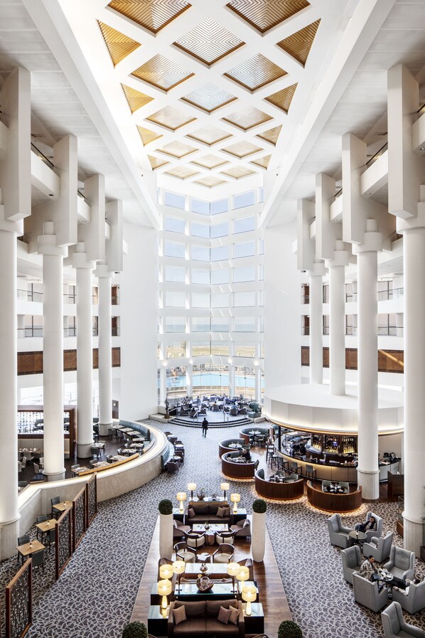 A spacious lobby with high ceilings, large windows, and a central seating area. - InterContinental David Tel Aviv by IHG (Tel Aviv)