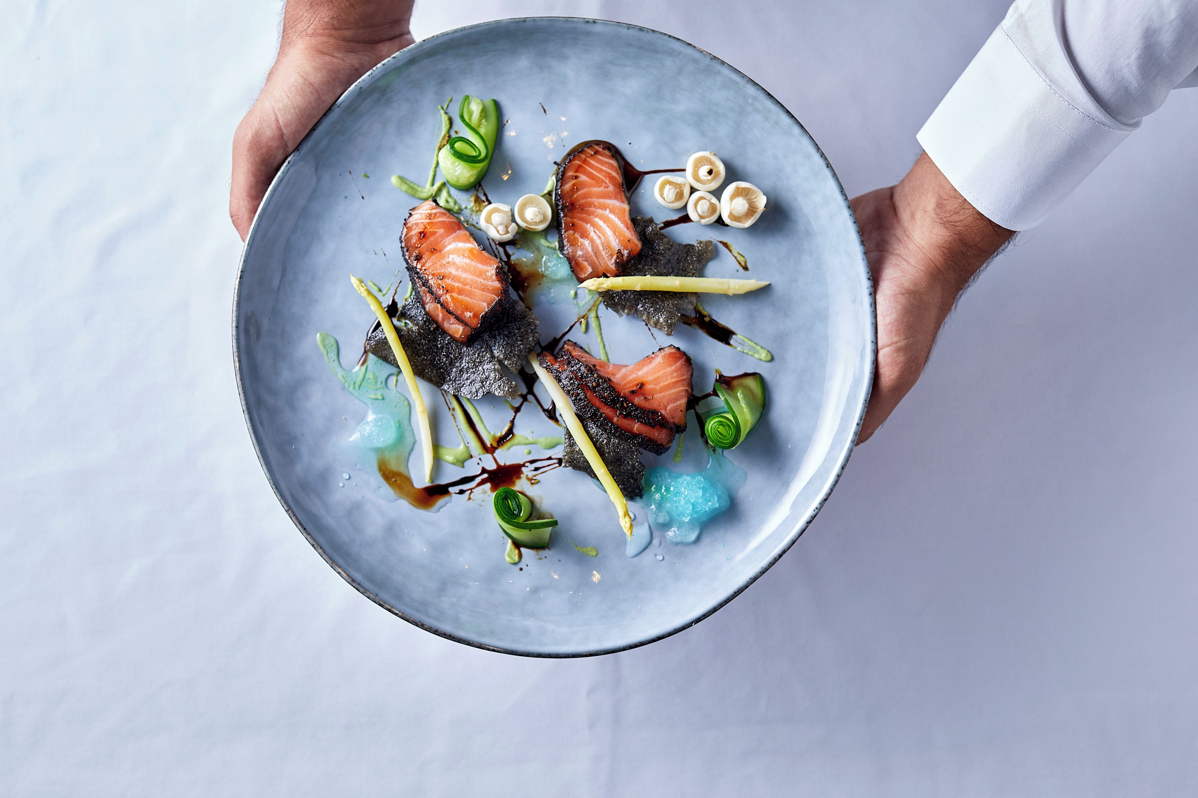 A person holding a plate with food.