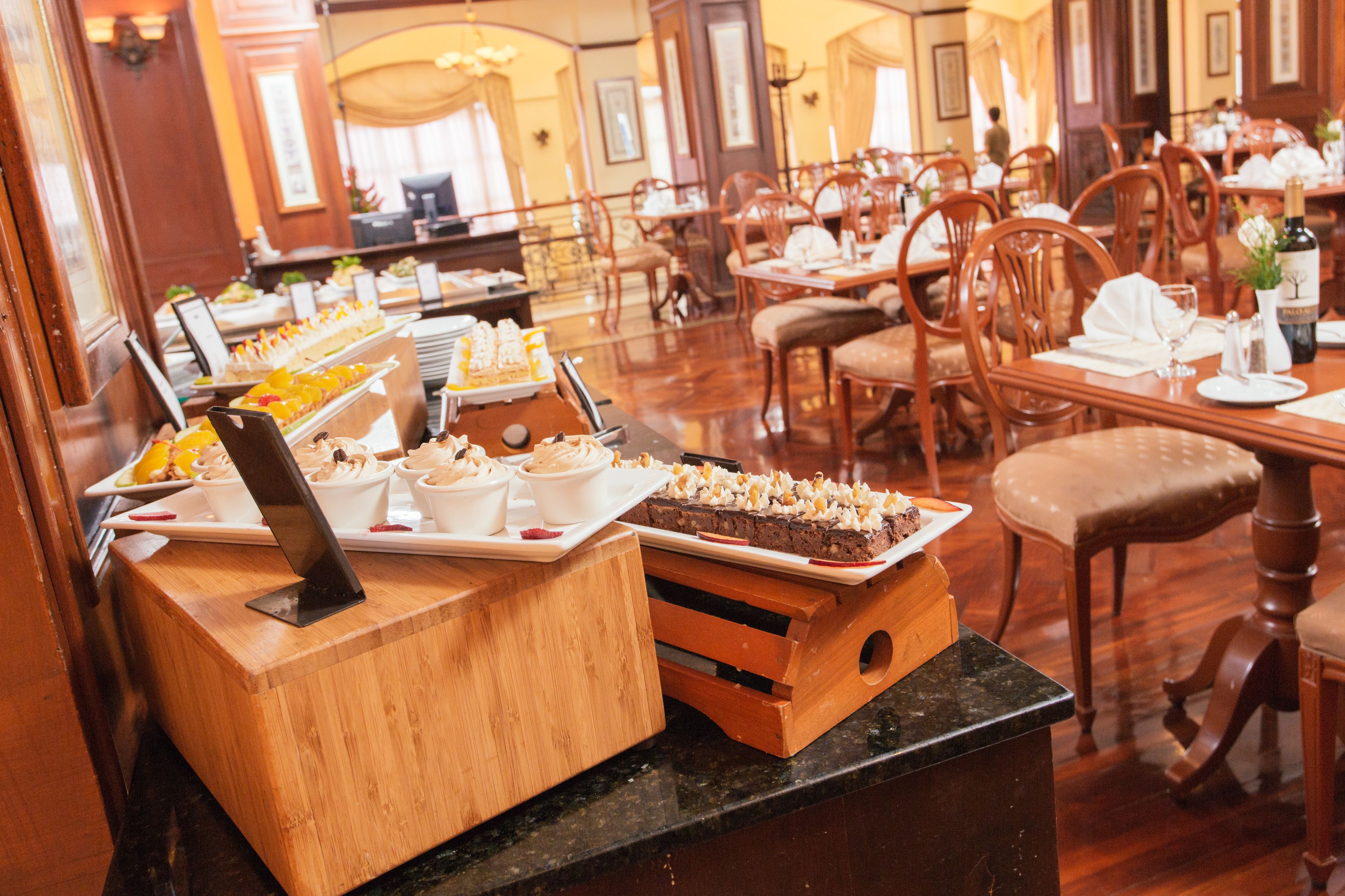 A buffet setup with various food items and a wooden counter.