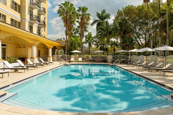 Outdoor pool, open 6 AM to 10:00 PM, pool umbrellas, pool loungers