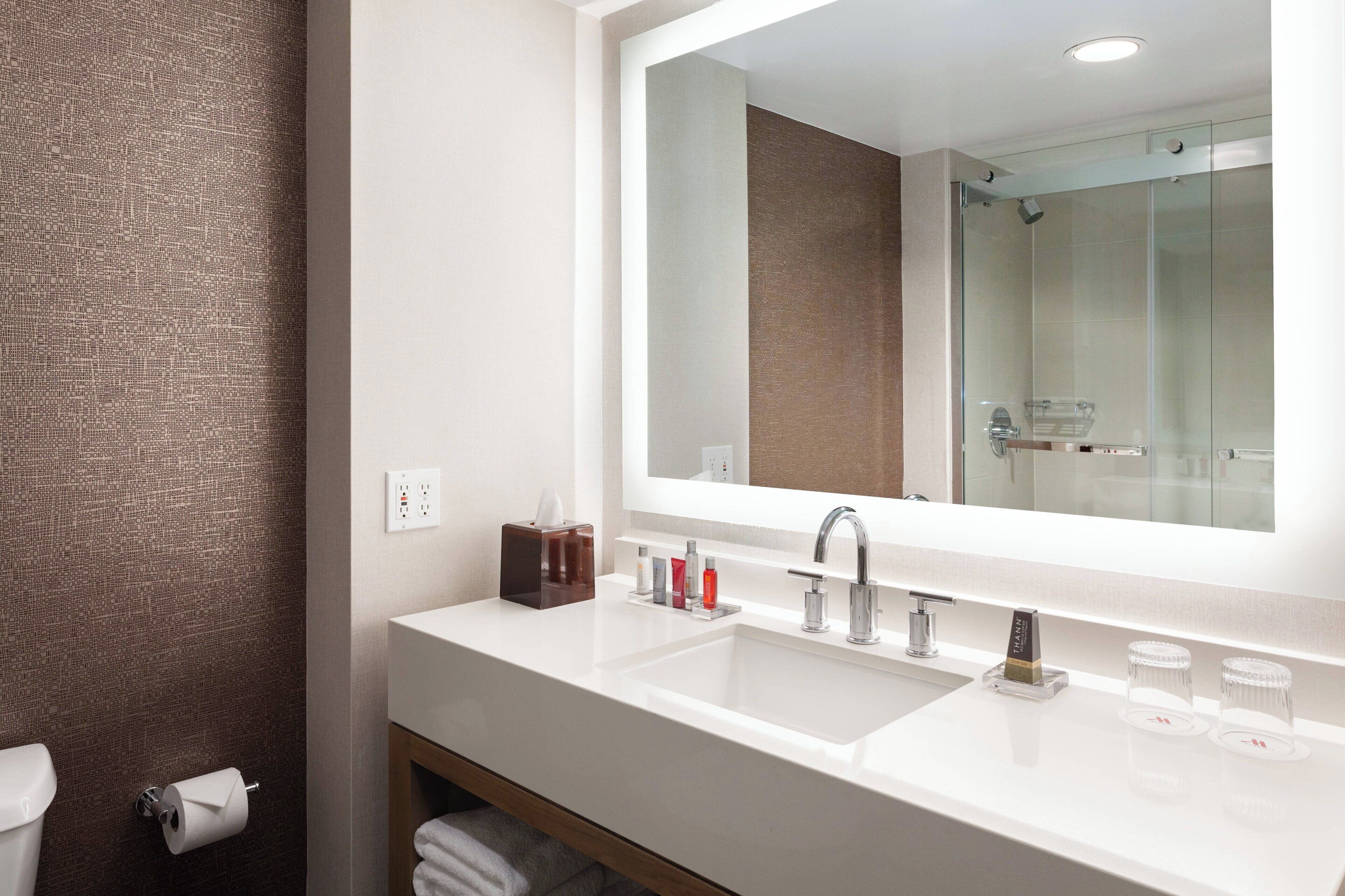 combined shower/bathtub, designer toiletries, hair dryer, towels