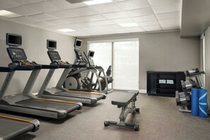 Stay active with our fully equipped gym featuring treadmills, a bench, and dumbbells.