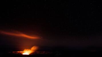 A night sky with stars and a visible light source at the bottom.