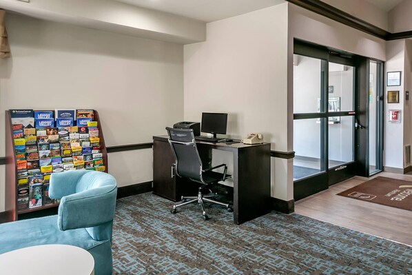 A hotel room with a desk, chair, and a bulletin board with travel brochures. - Sleep Inn Allentown - Fogelsville (Allentown)