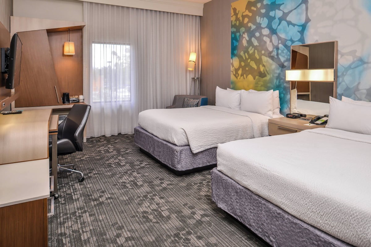 Premium bedding, desk, laptop workspace, blackout drapes